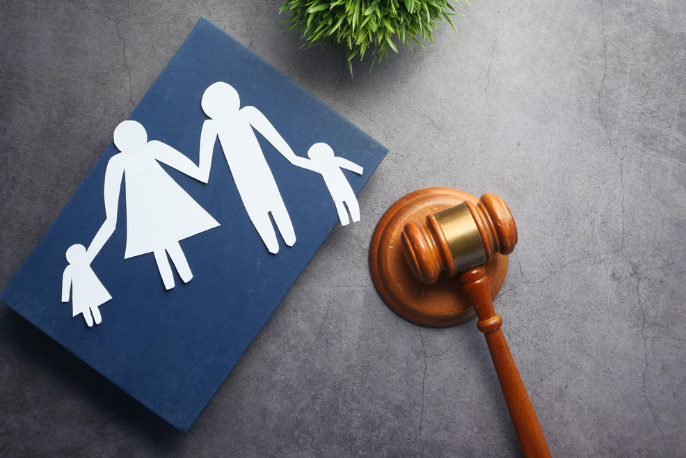 The Concept of Family Law. Family with Children Cutout and Gavel on Table.